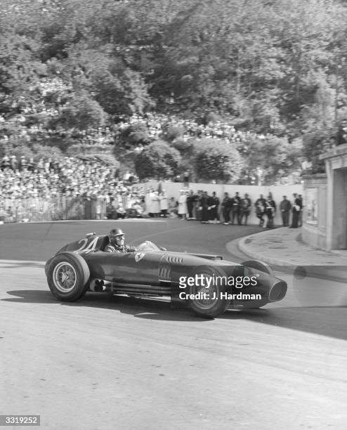 British racing driver Mike Hawthorn at speed at Gasmeter Hairpin during the 1957 Monaco Grand Prix, driving a Ferrari.