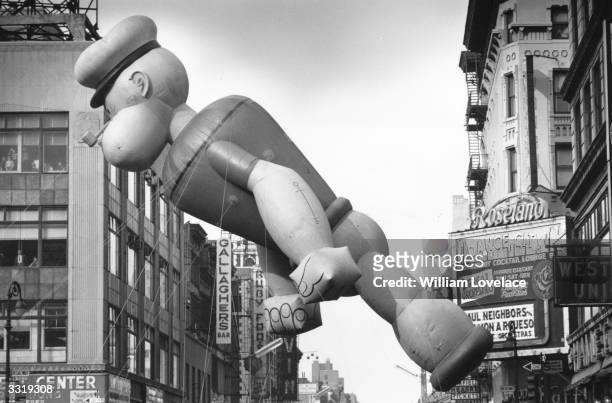 An inflated Popeye floats above the Thanksgiving Day Parade in New York as it nears Times Square.