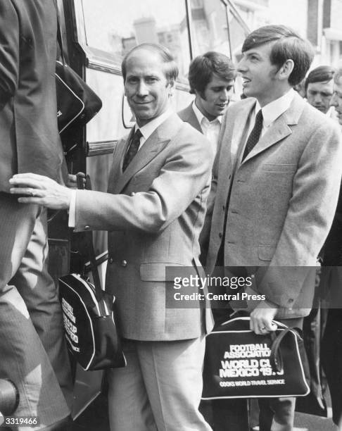British footballer Bobby Charlton with Martin Peters and Geoff Hurst boarding a bus taking the England squad to London Airport where they fly out to...