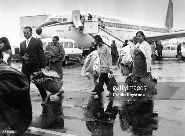 Ugandan Asians arrive at Stansted Airport on the first of several specially chartered flights to Britain shortly after Ugandan military dicatator Idi...