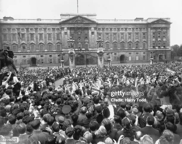 Day, held to commemorate the official end of Britain's involvement in World War II, is celebrated by a crowd outside the gates of Buckingham Palace....