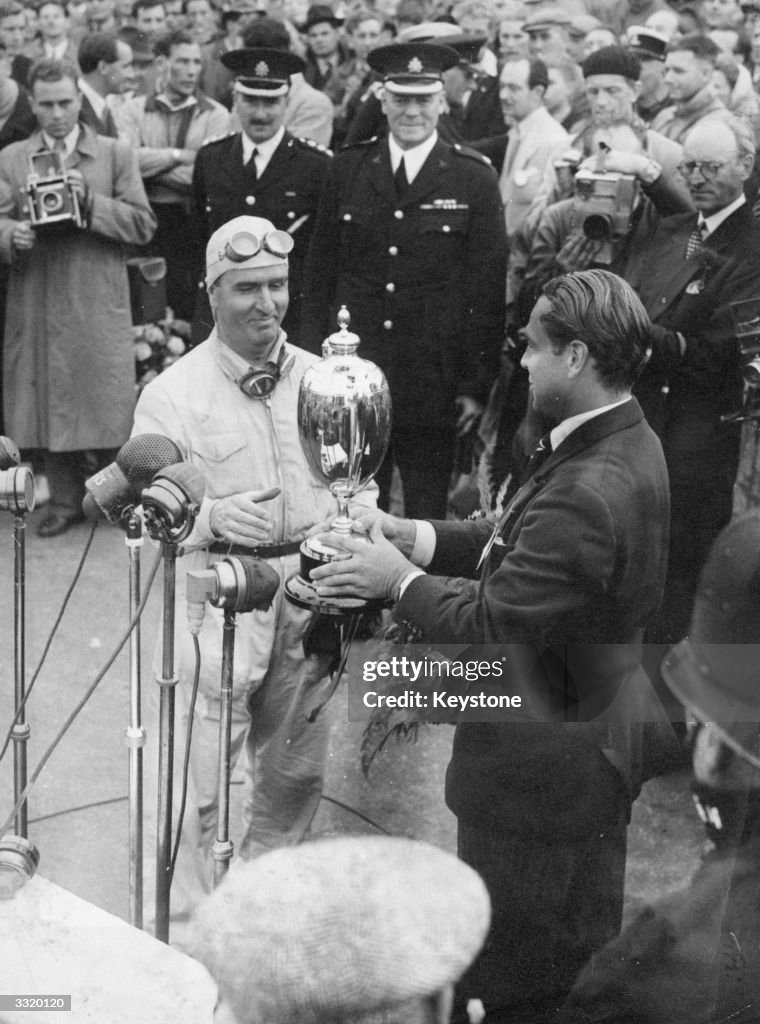 Farina Racing Driver Italian racing driver Giuseppe Farina receives the trophy from Max ...