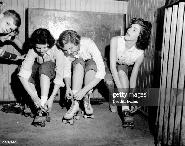 Group of young women putting their roller skates on at their Sunday School in Virginia.