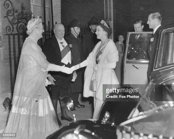 Queen Elizabeth II and Prince Philip are greeted by Sir Winston and Lady Churchill as they arrive outside 10 Downing Street for a dinner party at the...