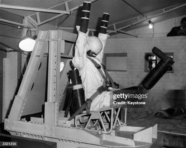 During testing of car safety belts at the British Standards Institution at Hemel Hempstead, a trolley-mounted dummy which travels along a 100 ft...