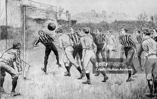 Player heading the ball towards the goal during a football match between Blackburn Rovers and Nottingham County. Original Publication: Illustrated...