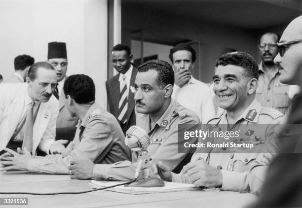 Egyptian leader Muhammad Naguib with Gamal Abdul Nasser , during a press conference, a year after the coup d'etat in Cairo which banished King Farouk...