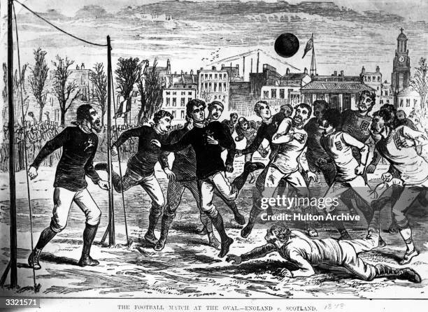 Players competing for the ball during an England versus Scotland football match at the Oval, England. The first recorded international football...