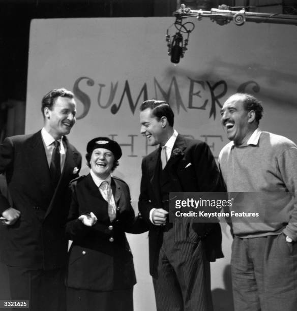 Jill Summers enjoys a joke with Nicholas Parsons, Terence Alexander and Harry Lane in front of a backdrop for her show 'Summers Here' at ITV Studios,...