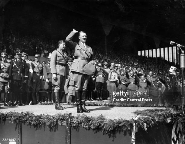 German chancellor Adolf Hitler salutes a crowd of 60,000 at a Hitler Youth rally at Nuremberg.