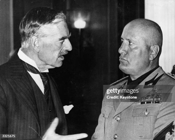 British prime minister Neville Chamberlain talks to Italian premier Benito Mussolini during the Munich Conference.