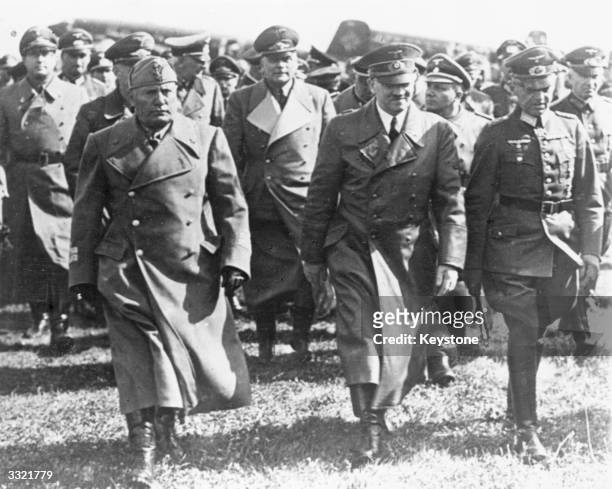 Italian prime minister Benito Mussolini with leading Nazis, including German dictator Adolf Hitler , during a visit to Germany during World War II....