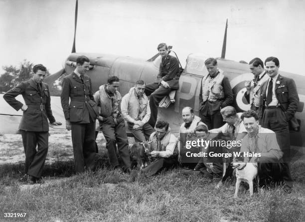 Spitfire pilots at a Fighter Station in southern England relax after operations with their mascots - amongst these is 'William E Goat'.