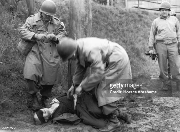 Self confessed Nazi spy Richard Jarczyk is examined an declared dead after his execution by US Army doctors. Jarczyk had confessed to operating...
