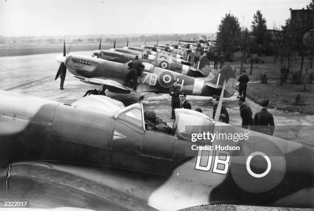 Group Captain Douglas Bader sits in the cockpit of his Supermarine Spitfire, preparing with other pilots to take off for the 'Battle of Britain Day'...