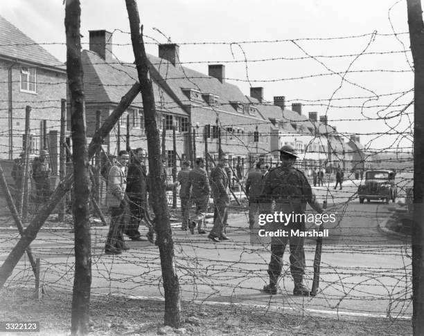 British soldier guarding an internment camp for 'enemy aliens', at Huyton housing estate in Liverpool.