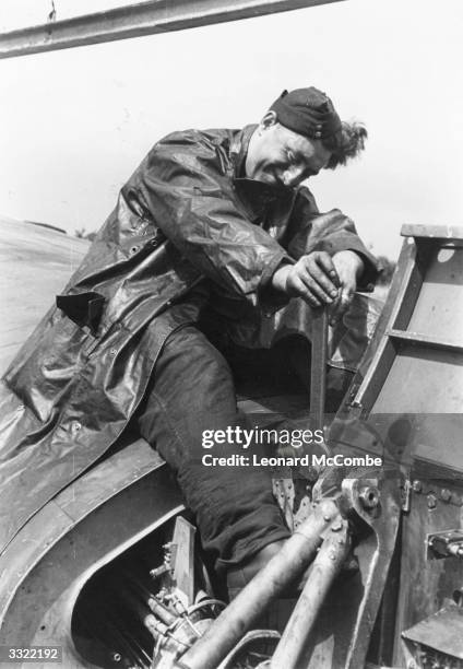 Break-up man working for the RAF Repair and Maintenance Service gets to work on the main sub-section during the dismantling of a shot-up Lancaster...