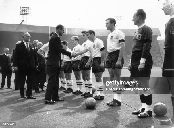 Prince Philip, Duke Of Edinburgh meets the England football team ahead of their British Home Championship game against Scotland, which they won by...