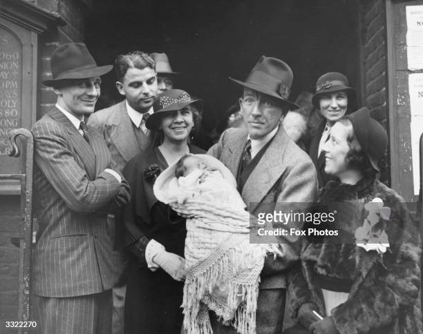 At the christening of Welsh playwright and actor Emlyn Williams' son Alan are, from left to right, actor and producer Sir John Gielgud , Emlyn...