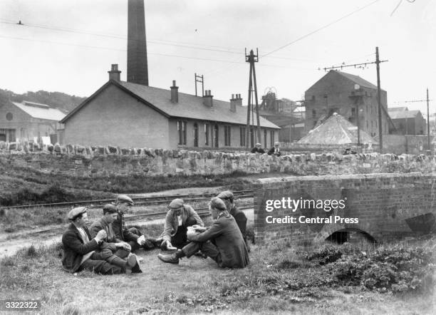 Group of miners passing the time with a game of cards outside Prestonpans Colliery, East Lothian, during industrial action at the time of the General...