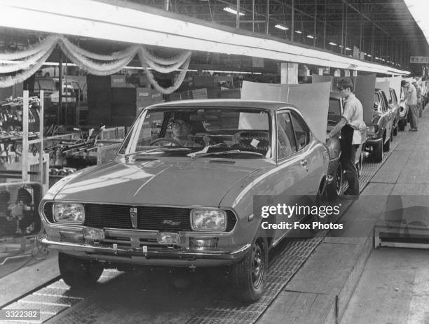 Japanese factory workers assembling cars on a production line in Japan.