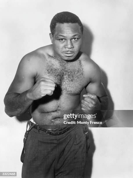 World light-heavyweight boxing champion Archie Moore spars for thecamera when in London for a championship fight against Yolande Pompey.