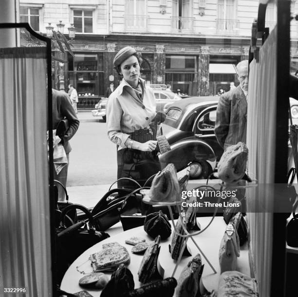 Window shopping on the Rue de la Paix in Paris. The famous Cartier jewllery store can be seen across the road .