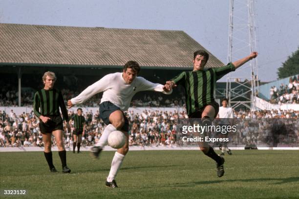 Alan Mullery in action for Tottenham Hotspur.