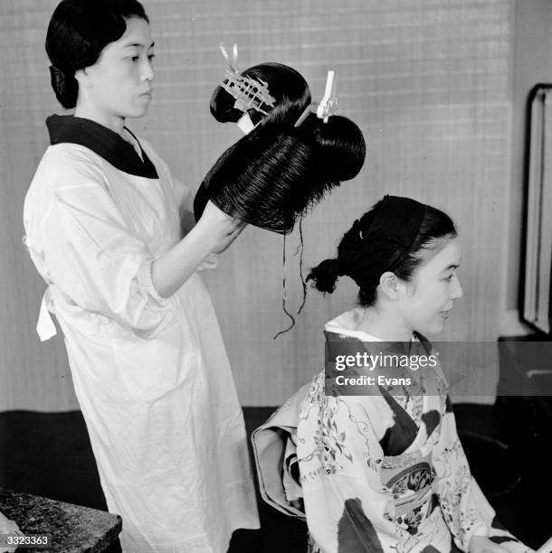 Japanese girl having a wig attached.