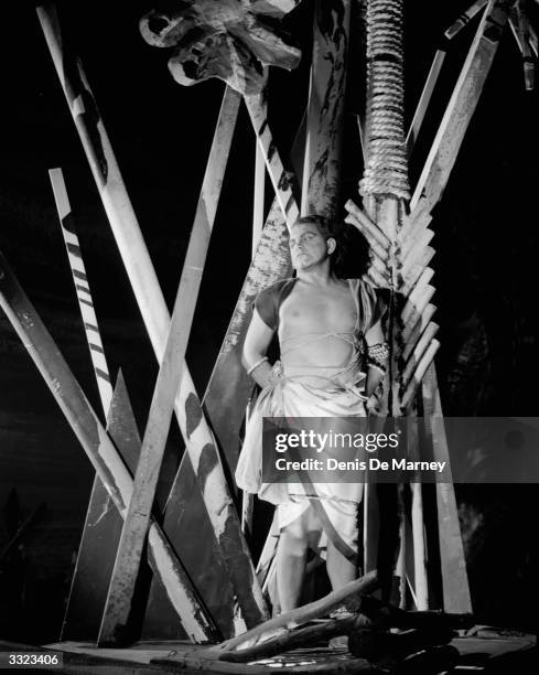 Singer Robert Thomas in a production of Bizet's 'The Pearl Fishers' at Sadler's Wells, London. Sets are designed by John Piper.