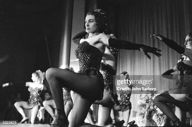 Can-Can girl Regine performing with the rest of the troupe at the Moulin Rouge in Paris.