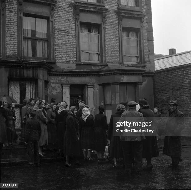 Police officer guards the entrance to 10 Rillington Place, Notting Hill in London, as crowds visit the house, scene of several murders committed by...