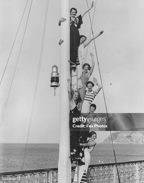 Group of holiday girls up on the signalling mask at the end of Llandudno Pier.