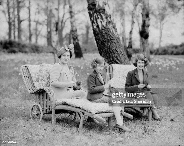 Queen Elizabeth, Queen Consort to King George VI with her daughters Princess Margaret Rose and Princess Elizabeth in the grounds of the Royal Lodge,...