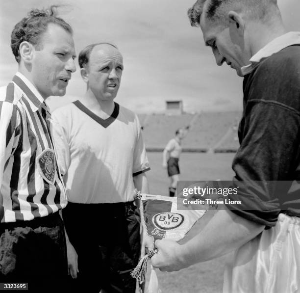 The teams captains of Chelsea and Borussia Dortmand football clubs exchange club memorabilia shortly before the kick off of a match in New York.