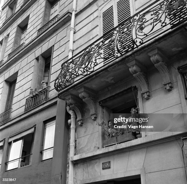 Residents of the Quai des Orfevres in Paris watch the filming of 'Father Brown', a film based on the famous priest detective created by G K...