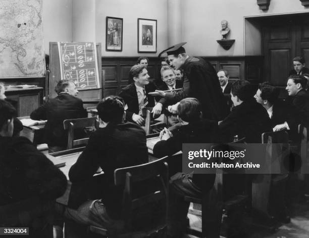 British comic actor Will Hay in a classroom scene from the film 'Good Morning Boys', directed by Marcel Varnel for Gainsborough.