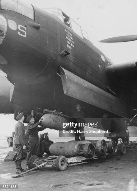 British troops load up a Lancaster warplane.