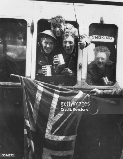 Members of the British Expeditionary Force arrive back in Britain with a Union Jack after being evacuated from Dunkirk.