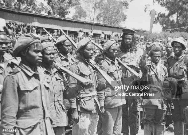 Field Marshal Mwariama inspects his troops at a Mau Mau hideout in Meruland.