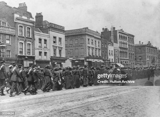 Salvation Army procession in the East End of London. Many of the women are holding tambourines.