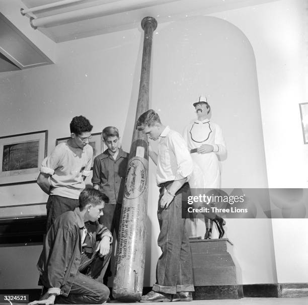 Group of boys viewing the worlds biggest baseball bat at the Cooperstown Baseball Hall of Fame and Museum, New York.