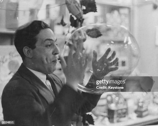 Man tries out a plastic balloon-blowing kit while shopping for Christmas at Gamages in London.