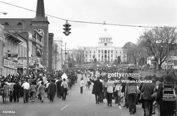 American civil rights demonstrators, led by Dr Martin Luther King, approach the Capitol Building in Montgomery, Alabama, at the end of their march...