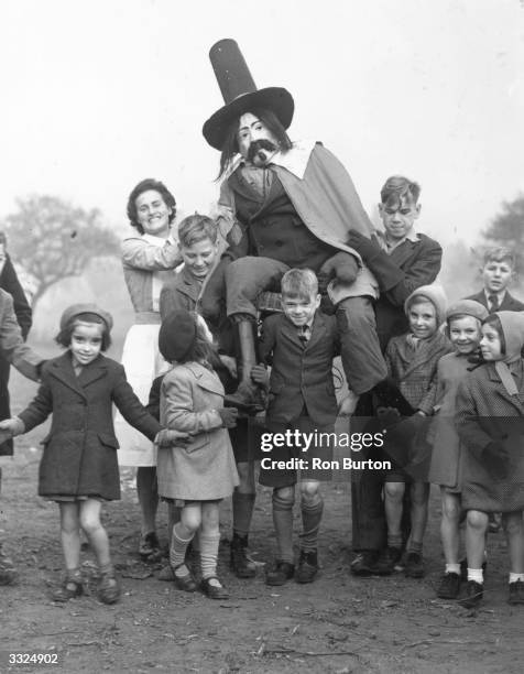 The staff and children of the Aldersbrook Children's Home, Wanstead, celebrating Guy Fawkes Day.