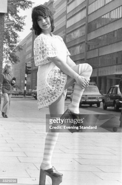 Model Sue Coddington, wearing typical 1970's fashion, shows off the eight inch heels on her platform shoes.