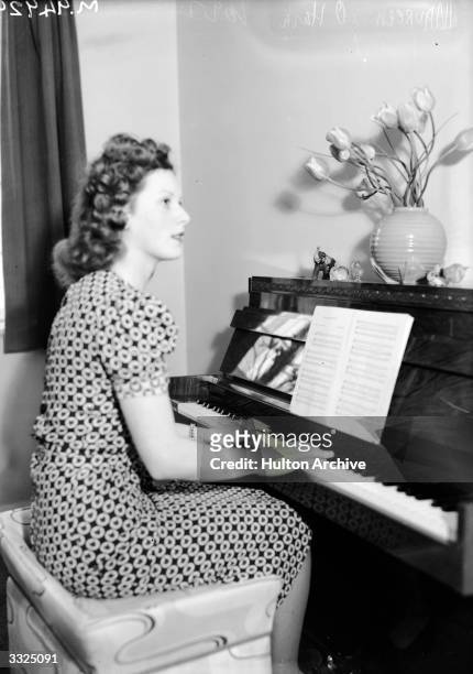 Irish actress Maureen O'Hara playing the piano.