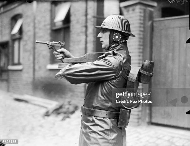 Futuristic soldier aiming a gun during the filming of Pemberton Billings 'High Treason' at Shepherds Bush.