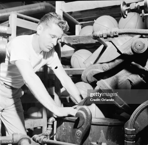 Basket balls moulds are baked at the Spalding plant, Chicopee, Massachusetts.