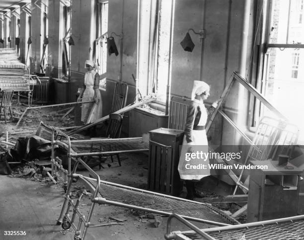 Nurses clearing up a wrecked ward at Park Hospital after a German bombing raid, Hither Green Lane, Lewisham, London, 12th September 1940.